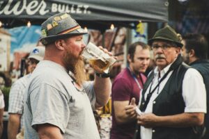 A lively scene at Oktoberfest in Nampa, Idaho featuring people enjoying beer outdoors.